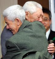 Former Japanese soldier Ishinosuke Uwano, foreground, hugs his younger brother Ushitaro Sadake as they reunite for the first time in 63 years in Morioka, Japan. Uwano, 83, recently surfaced in Ukraine after he went off to fight in World War II. On Thursday he had a teary reunion with the 80-year-old brother and his relatives near his hometown.