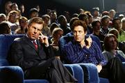 The President (Dennis Quaid), left, suffers an untimely earpiece malfunction while judging a TV show run by Martin Tweed (Hugh Grant), in "American Dreamz."