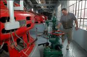 David Readio, who has helped to keep the Bowersock Power Plant running for 17 years, does his daily check of the plant, which is on the banks of the Kansas River.