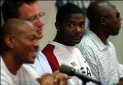 Sprint Capitol runner Justin Gatlin listens to HSI runner Maurice Greene, left, talk about Saturday's Gold Zone competition during a press conference Friday at Memorial Stadium. To Gatlin's left is Kansas Relays meet director Tim Weaver, and far right is Sprint Capitol coach Trevor Graham.