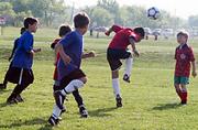 Members from Ottawa United and the Fire Dragons continue play in the morning sun. The two teams hit the field Saturday morning at Youth Sports Inc. United took the close win, 7-5.