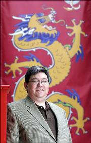 Bill Tsutsui will be the exectutive director of the Confucious Institute, which will open in August at Kansas University. The institute will provide chinese language instruction and programs on Chinese culture. Tsutsui is pictured on Tuesday in front of a banner of a Chinese dragon outside the Spencer Museum of Art at KU.