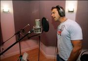 Puerto Rican singer Carlos Ponce sings on a track while recording a Spanish-language version of the U.S. national anthem, Wednesday, April 26, 2006 in Miami. The recording, dubbed "Nuestro Himno," which means "Our Anthem" in English, is set to "rhythmic Latin musical arrangement" but respects the song&squot;s traditional structure, said Adam Kidron, who heads the record label Urban Box Office.