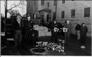 Lawrence law enforcement pour bottles of illegal liquor down the sewer drain outside the sheriff's headquarters in this undated photo.