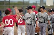 Panthers first baseman Chris Allen leads his team through the high fives after the game. The Panther defeated the Comets April 24 at Youth Sports Inc.
