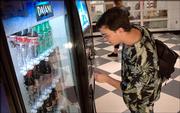 Lawrence High School sophomore Zach Guy selects a soft drink from a vending machine in the commons area at LHS. Soft drink companies on Wednesday announced that they will stop selling most sodas in the nation's public schools.