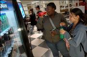 Lawrence High School students Stella Finch, left, sipping on a Fanta Strawberry soft drink and Sarah Jackson, with a Sprite, say they often get a soft drink during lunch or at the end of the school day. Soft drink companies today announce nationally they are voluntarily removing high-calorie, sugary drinks from schools.
