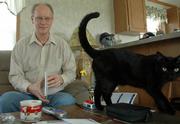 Charlie Ross, Lawrence, who has bipolar disorder and attention deficit disorder, says it ought to be all right to talk about mental illness. "I just want people to know what it&squot;s like," said Ross, who is pictured at his house with his cat, Frodo. Ross works as a rural outreach specialist with Independence Inc. and is helping to organize this week&squot;s National Alliance on Mental Illness fundraiser walk.