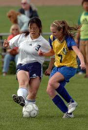 Seabury Academy's Kathy Chung (3) controls the ball while Center Place's Molly Hight defends. The Seahawks won Thursday's game, 4-3, at the Youth Sports Inc. fields.