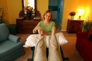 Lawrence resident and reflexologist Julie Vernon works on the feet of her client Sarah Fayman, of Lawrence. Vernon has been practicing reflexology, particularly for the hands and feet, for 10 years and describes it as a noninvasive practice that helps stimulate the body's circulatory system.