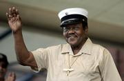 Fats Domino waves to the crowd after briefly appearing on stage Sunday during the 2006 New Orleans Jazz and Heritage Festival in New Orleans. Domino canceled his performance at the 37th annual event. It was to be his first since he was rescued by boat from his flooded home in the Ninth Ward after Hurricane Katrina struck on Aug. 29.