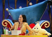 Melanie Martinez, who plays Melanie the baby sitter, laughs during taping as she sits with Star the puppet on the studio set for "The Good Night Show" in Paulsboro, N.J. The television show is broadcast on PBS KIDS Sprout, a 24-hour national cable and satellite network aimed at the youngest television viewers.