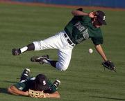 Free State High outfielder Travis Ice misplays a fly ball allowing a Lawrence High to score a run during the second inning.