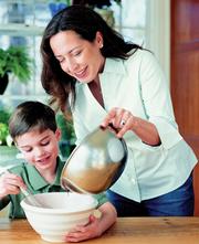 This photo provided by Potter shows chef-caterer Debra Ponzek cooking with her son Cole Addonizio. The photo is from "The Family Kitchen," Ponzek&squot;s cookbook with recipes for parents and children "to make and enjoy together."