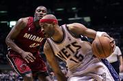 New Jersey's Vince Carter (15) dribbles past Miami's James Posey during the fourth quarter. The Heat beat the Nets, 102-92, Sunday in East Rutherford, N.J., to take a 3-1 lead in the series.