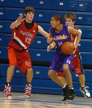 Ft. Sooy No Limit's Verdell Jones, center, attempts to elude K.C. Pump N Run's Conner Teahan, left. Jones and Teahan both list Kansas University as a possible college choice.