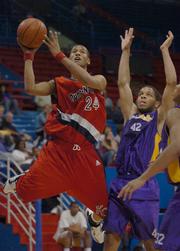 K.C. Pump N Run's Travis Releford, left, puts up a shot over two Ft. Sooy No Limit players. Releford's team prevailed, 62-57, Sunday in Allen Fieldhouse.