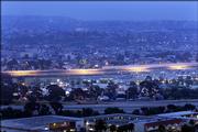A view of the well-lighted fence at the U.S.-Mexican border is seen from San Ysidro section of San Diego, with the Mexican city of Tijuana in the background. The Senate on Wednesday approved a plan to add up to 350 miles of border fencing.