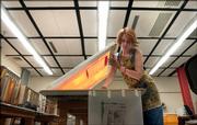 Kansas University student Leigh McHatton will celebrate her graduation on Sunday. McHatton, shown finishing a final printmaking project Thursday at KU, was burned in the Oct. 7 fire at Boardwalk Apartments and still has nightmares about the blaze.
