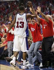 The Clippers' Quinton Ross celebrates with fans after hitting a shot in the waning seconds of the second quarter. The Clippers beat the Suns, 118-106, Thursday in Los Angeles to even their series at three game apiece.