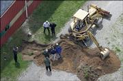 Workers dig near a barn at a horse farm in Milford Township, Mich., where FBI agents investigating Jimmy Hoffa's 1975 disappearance were working for a second day Thursday. The Teamsters leader had vanished from a restaurant in Bloomfield Township, about 20 miles away.