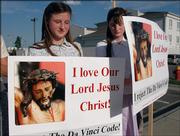 Twins Angelik and Cecilia Hiepert, 12, of Newbury were among 12 protesters who showed up Friday to express their displeasure for "The Da Vinci Code" outside the Hollywood Southwind 12 Theater at 3433 Iowa.