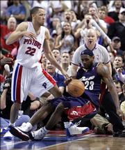 As Detroit forward Tayshaun Prince, left, looks on, Cleveland's LeBron James stumbles and loses a possession during Game 7 of the teams' NBA playoff series. The Pistons won, 79-61, Sunday in Auburn Hills, Mich.