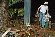 Ramon Powers, at left, hauls junk at the Black Jack site. Volunteers have assisted with cleanup efforts at the site.