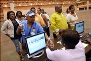 Joyce Spruille, Front left, gets a scan of her wristband during a mock evacuation drill in New Orleans. Tuesday was the first day of a two-day drill aimed at avoiding the chaos that followed last year's Hurricane Katrina.