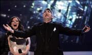 Taylor Hicks reacts after being announced the winner of season five of "American Idol." Pictured in the background Wednesday is runner-up Katharine McPhee.