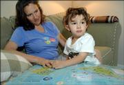At 2 1/2 years old, Tavi Shaffer-Green looks for Easter Island on a world map with his mother, Tanya Shaffer. Tavi can pick out every country on a world map, including Togo, which he likes because of its tiny size. Tavi also is the son of David Green. Shaffer is a Lawrence High School graduate, and her father, Harry Shaffer, is a longtime economics professor at Kansas University. Green was the recipient of the MacArthur Fellowship - or "genius award" - in 2004.