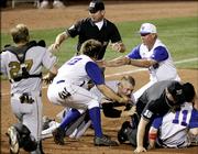 Third-base umpire Doug Williams, center rear, and home-plate umpire Chris Coskey try to get between Missouri's Brock Bond and Kansas' Ryne Price (11) during a second-inning fight that started when Price and Bond collided after Price homered. Both were ejected.