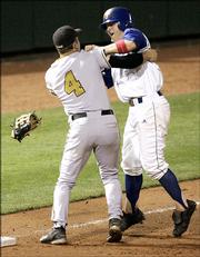 Missouri's Brock Bond, left, and Kansas' Ryne Price get in a fight after the two collided in the second inning. Both were ejected from the game Saturday in Oklahoma City.