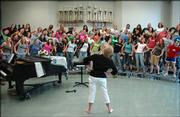 After 31 years in Lawrence Public Schools, Free State High School vocal music director Pam Bushouse is retiring. Bushouse leads a choral class at FSHS in some stretching exercises before a rehearsal.