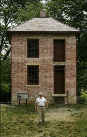 Shawnee County Historical Society trustee Bill Wagnon walks away from the partially restored John Ritchie house in Topeka.