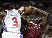 Detroit center Ben WAllace, left, blocks a shot by Miami Heat center Shaquille O'Neal during the third quarter. Wallace and the Pistons shut down the Heat, 91-78, Wednesday night in Auburn Hills, Mich., and cut Miami's lead in the Eastern Conference finals to 3-2.