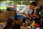 Auctioneer Doug Riat, Lawrence, moves through the crowded garage of Gilbert's the late Willie Stagg Thursday evening organizing over 5000 miniature stuffed animals collected by Stagg as he prepares for a two-day auction this weekend in which the family will sell many of Stagg's possessions including her many collectibles. In addition to the stuffed animals, some of the other notable collectors items are Stagg's 200 plus Barbie dolls and over 2000 albums.