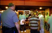 Police keep a heavy watch over Massachussetts Street around bar closing time. Last week, a patron offered a handshake to an officer on the sidewalk outside "It&squot;s Brothers Bar and Grill," 1105 Massachussetts Street.