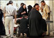The family grieve over the body of a market dove-seller at al-Kindi hospital, after two bombs struck in quick succession at a pet market in central Baghdad, killing at least five people and wounding 57 in Iraq Friday, June 2, 2006. The explosives were left in bags at the entrance and the center of the al-Ghazil market, where Iraqis can go every Friday to buy dogs, birds, snakes and other animals.