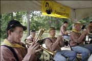 Members of the Blue and Gray Brigade perform a song during a celebration of the 150th anniversary of the Battle of Black Jack. The two-day event concluded on Saturday with a morning breakfast, character portrayals and guided tours. The site is home to the first documented clash between pro- and anti-slavery forces, which ultimately led to the Civil War.