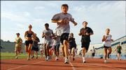 Red Dog's Dog Day runners start on one of two laps at Memorial Stadium at a previous year's event. Participants of all ages join in the annual exercise program, which starts today.