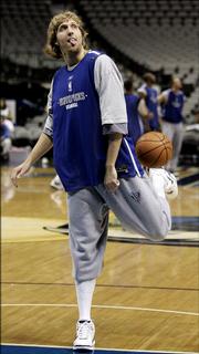 Dallas Mavericks forward Dirk Nowitzki kicks a basketball during practice. Nowitzki, pictured Friday in Dallas, worked on his footwork with professional fencers while training with basketball guru Holger Geschwindner.