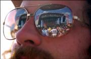 Chad Anders' sunglasses reflects part of the Wakarusa Festival crowd as Tea Leaf Green plays on Sunday. Anders said he had been listening to the band for about three years now, but not closely. Michael Franti was his favorite performance at the festival he said.