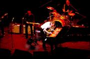 Jerry Lee Lewis, "The Killer" kicks over his piano bench with his cowboy booted foot while playing "Great Balls of Fire" at the Folly Theater in Kansas City, Mo Friday night. The 69 year old rock and role legend played before an audience of about 1,000.
