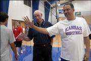 Kansas University assistant basketball coach Kurtis Townsend, right, and his dad, Raymond Sr., interact with campers at Bill Self's basketball camp. One of the elder Townsend's claims to fame is playing junior college basketball in San Jose, Calif., at the age of 39.