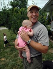 Stay-at-home dad Troy Kreutzer enjoys the time he can spend with his son AJ, 2, and his 3-month-old daughter, Ava. Troy takes care of the children and does most of the cooking and cleaning, all while tending the family's 16 acres near Oskaloosa on the weekends. Kreutzer's wife works as a sales manager for Wilmington Finance.