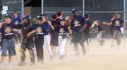 The Charleston Riverdogs line-up to slap hands with the Carolina Mud Cats on June 13 at Holcom Park. After both teams were tied throughout the third inning the Riverdogs broke through for the victory 6-3.