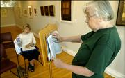Lawrence resident Eleanor Symons, right, leads a reading through the book of Exodus as Barbara Wasson follows along during a Bible reading Monday afternoon at Signs of Life, the art gallery and bookstore at 722 Mass. Signs of Life is sponsoring the reading, which began at 7 a.m. Monday and will continue through Saturday until the entire Bible has been read.