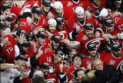 The Carolina Hurricanes celebrate with the Stanley Cup after defeating the Edmonton Oilers, 3-1, in Game 7 of the Stanley Cup finals. The Hurricanes won the Cup with Monday night's victory in Raleigh, N.C.