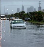 A stalled vehicle sits in high water along Interstate 45 in Houston. Torrential downpours created a nightmare commute for Houston-area residents on Monday, flooding some major traffic arteries.